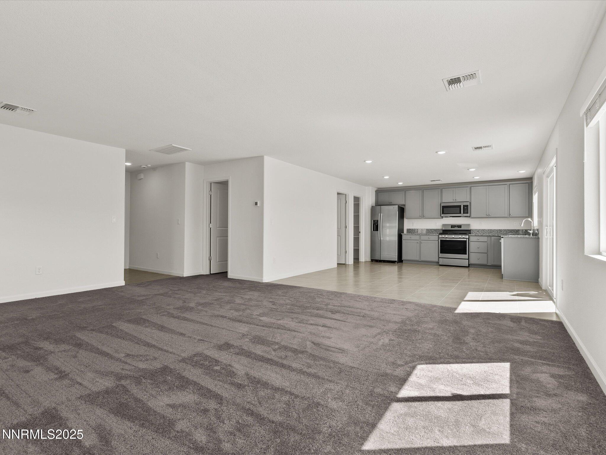 8838 Finnsech Drive Reno, NV 89506 - Photo 10 of 44 a view of kitchen with refrigerator stove and cabinets