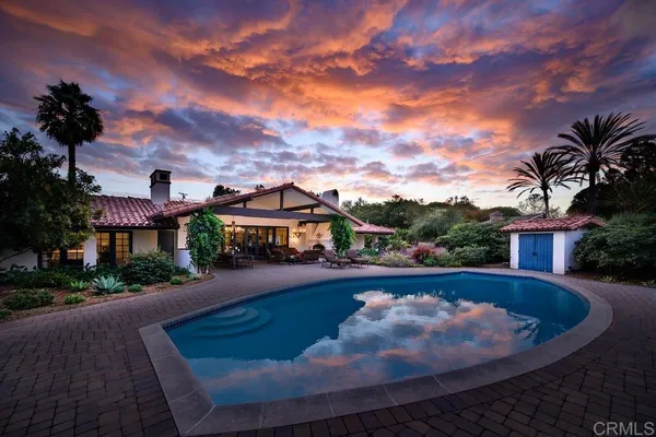 a view of a house with swimming pool and a yard