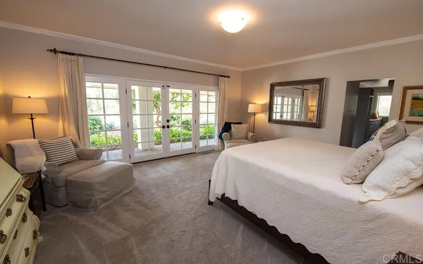 a spacious bedroom with a bed and a couch