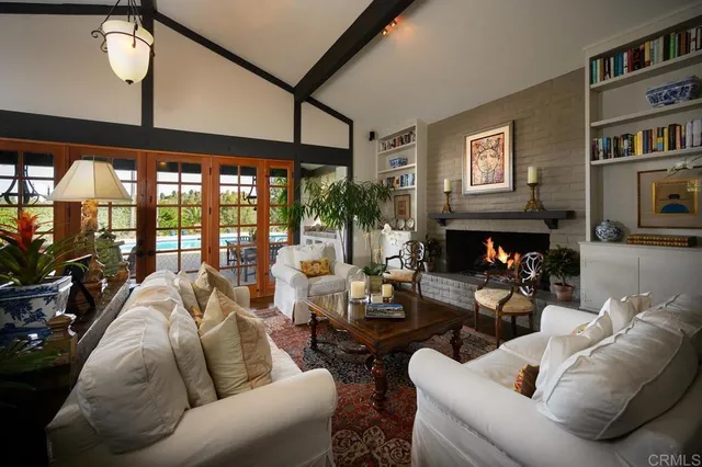 a living room with furniture a fireplace and a flat screen tv