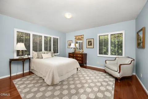 a bedroom with a large bed and a large window