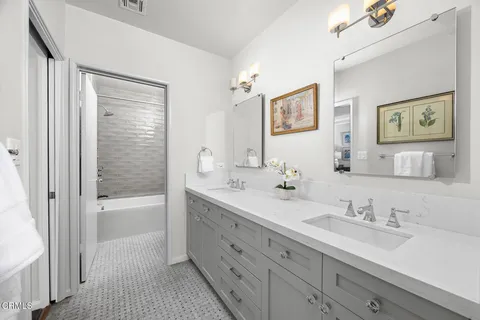 a living room with furniture and large windows