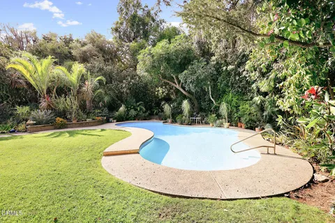 swimming pool view with a outdoor seating