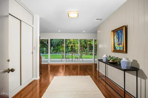 a living room with furniture and a floor to ceiling window