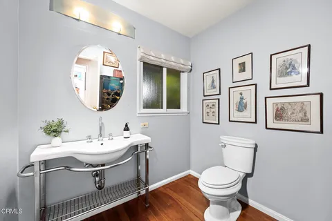 a bathroom with a sink toilet and a mirror