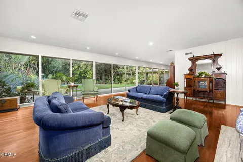 a living room with furniture and garden view