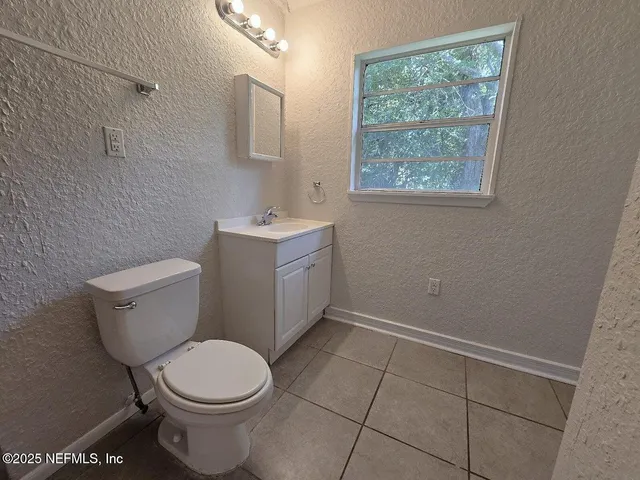 a white toilet sitting next to a bathroom sink
