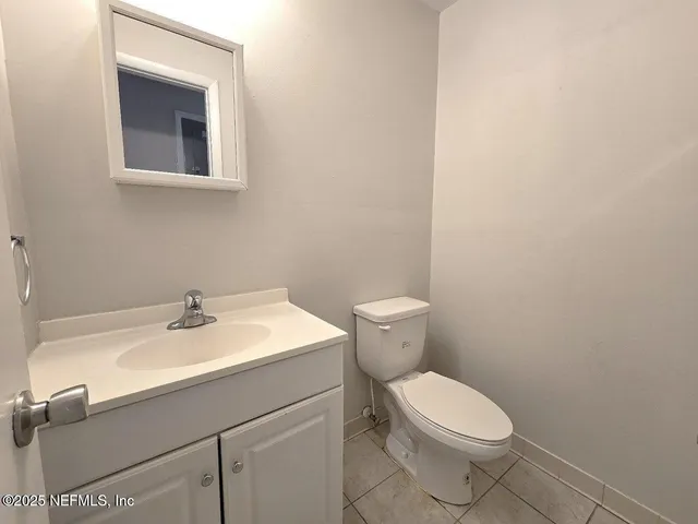 a white toilet sitting next to a bath tub