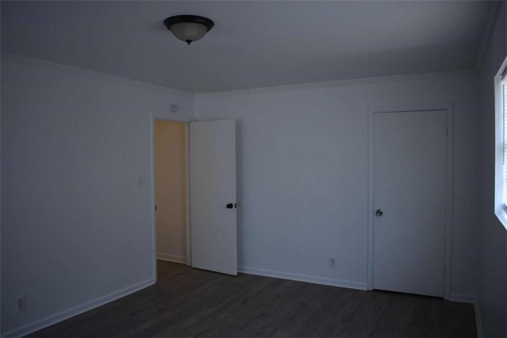 1156 Triple Hill Drive, Unit C Macon, GA 31206 - Photo 13 of 15 an empty room with wooden floor and windows