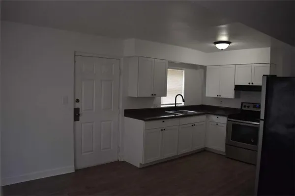a kitchen with a sink and refrigerator