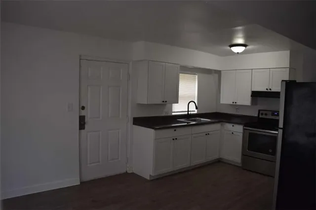 a kitchen with a sink and refrigerator