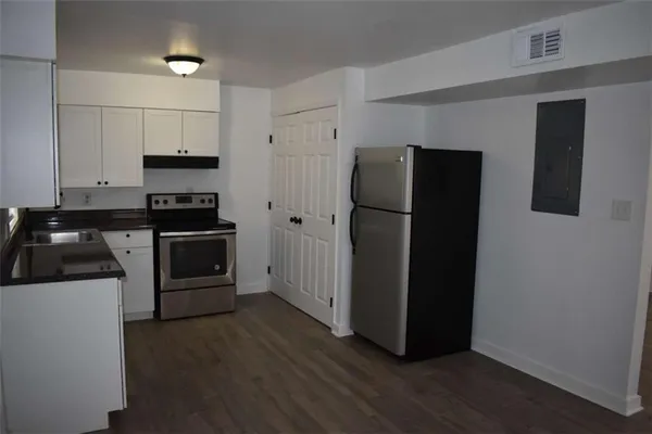a kitchen with stainless steel appliances a refrigerator and a stove top oven