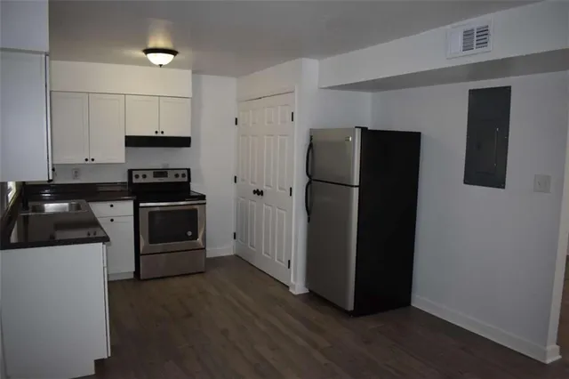 a kitchen with stainless steel appliances a refrigerator and a stove top oven