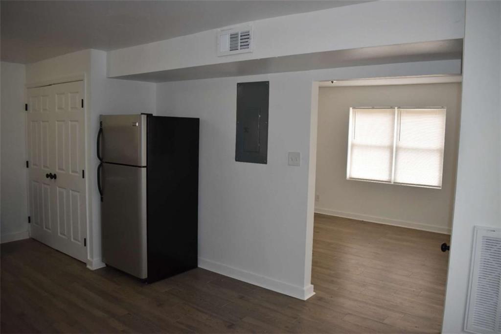 1156 Triple Hill Drive, Unit C Macon, GA 31206 - Photo 8 of 15 an empty room with wooden floor and a window