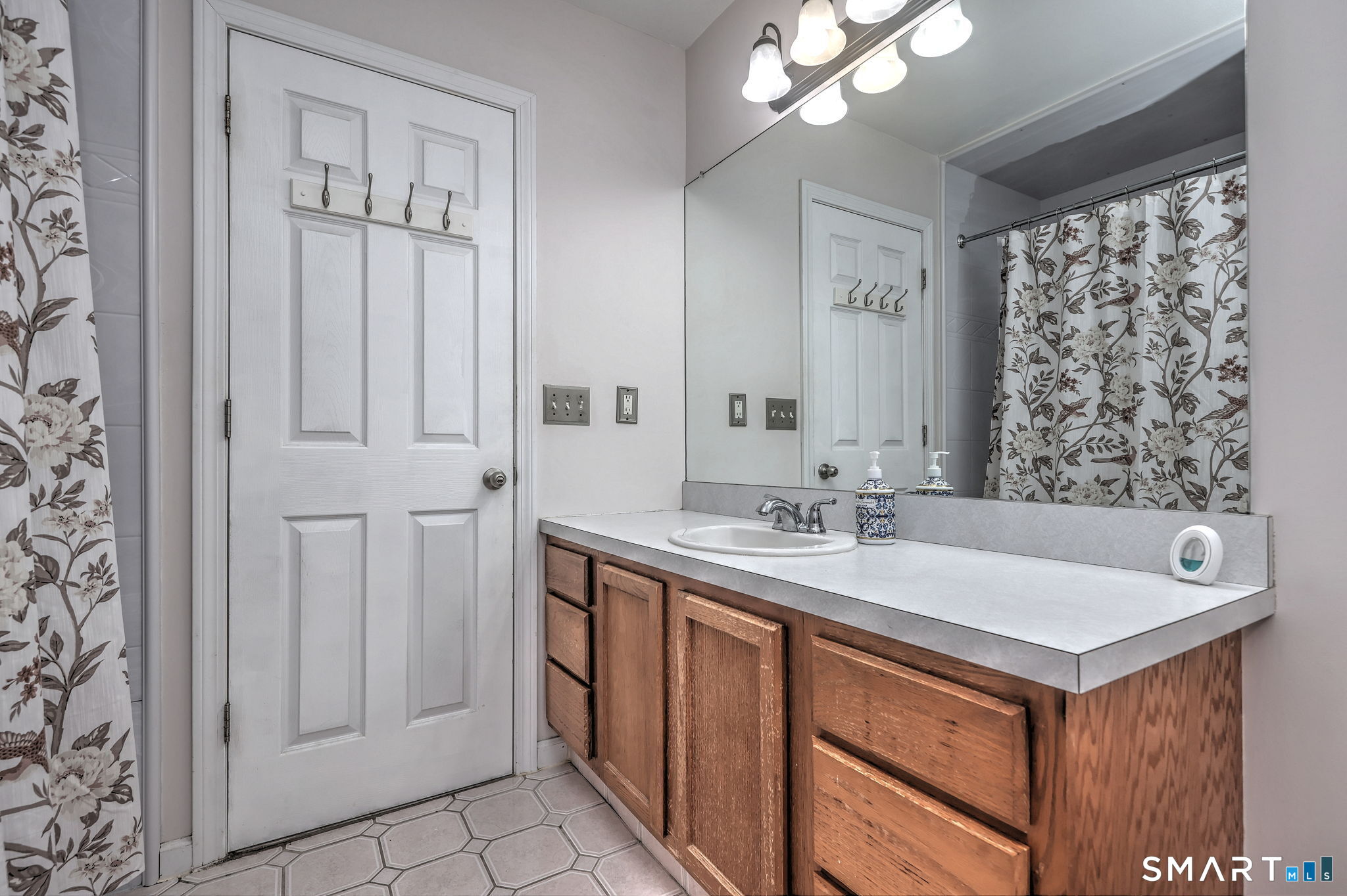 112 Finch Avenue Meriden, CT 06451 - Photo 22 of 40 a bathroom with a sink a mirror and a shower