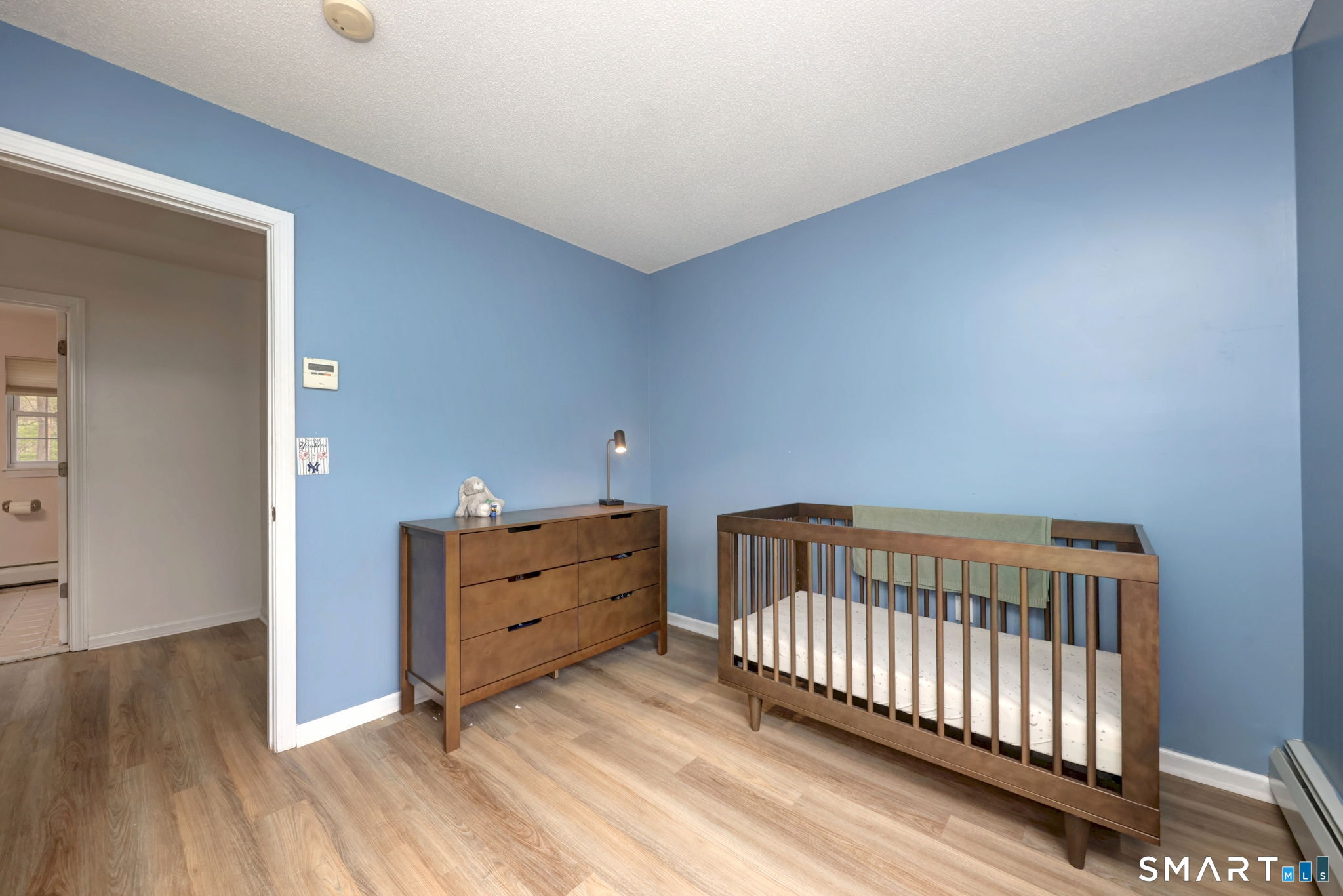 112 Finch Avenue Meriden, CT 06451 - Photo 29 of 40 a bedroom with a bed and wooden floor