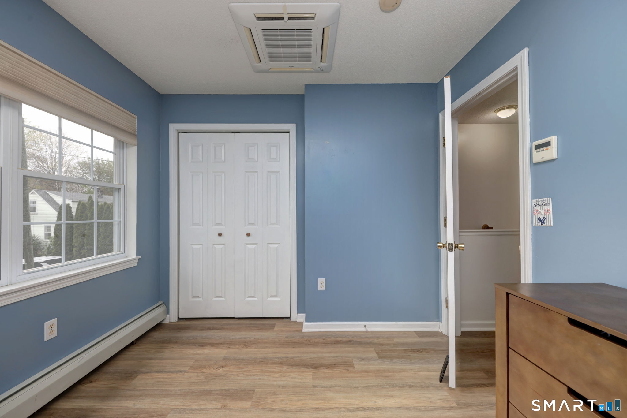 112 Finch Avenue Meriden, CT 06451 - Photo 30 of 40 a view of an empty room with wooden floor and a window