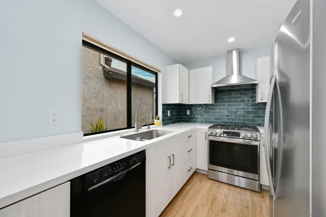 a kitchen with a sink stove and refrigerator
