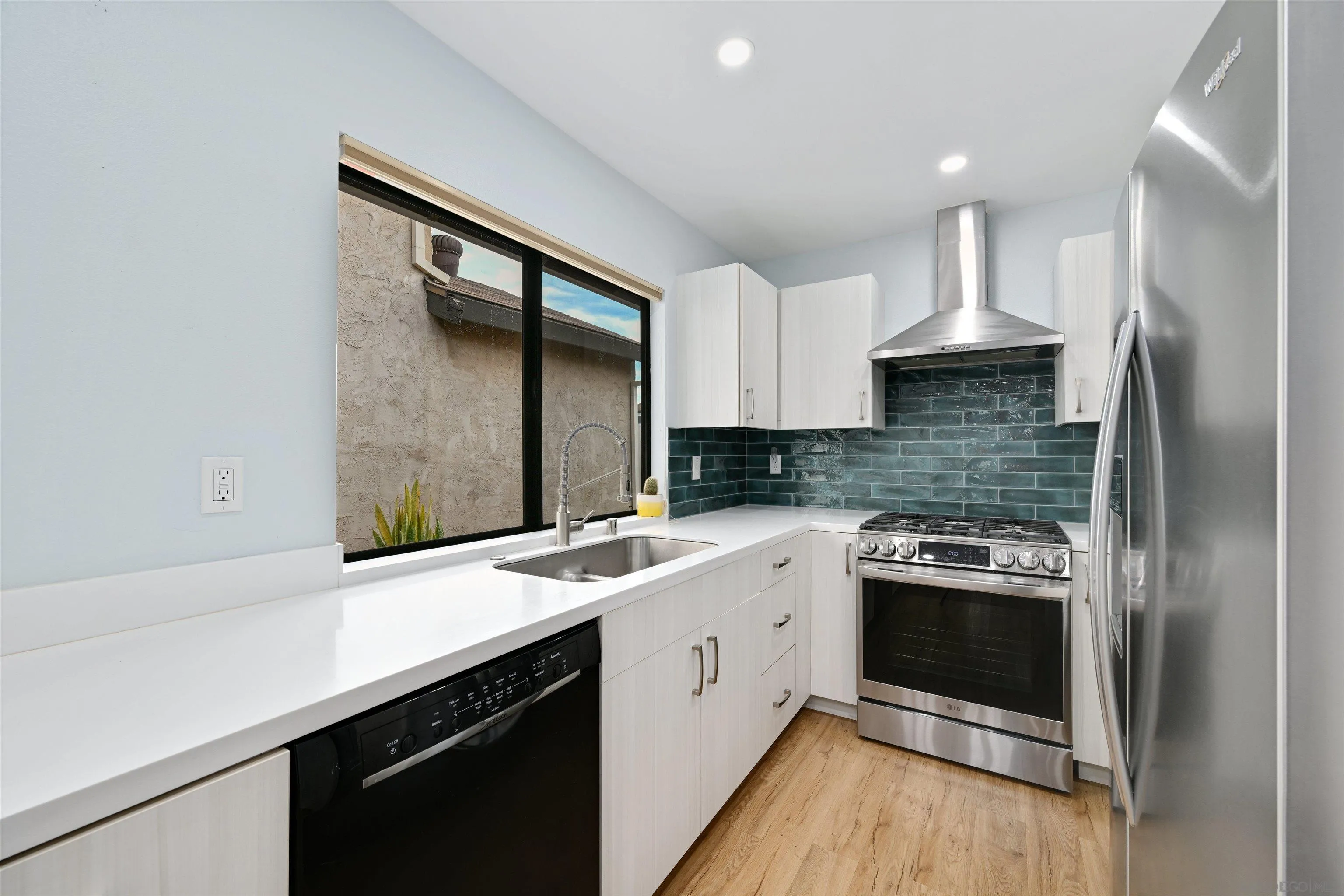 a kitchen with a sink stove and refrigerator