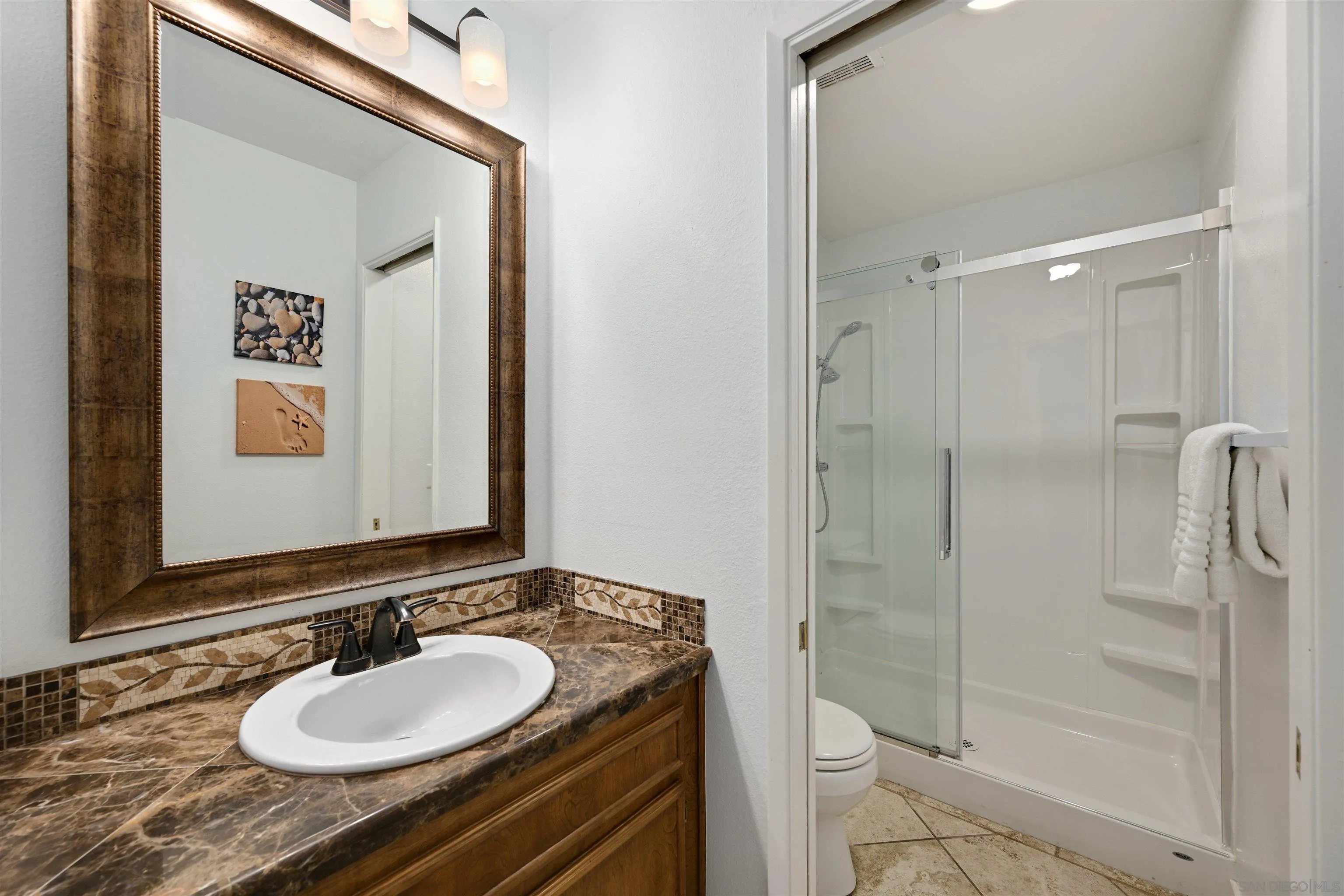 10314 Rochelle Avenue Santee, CA 92071 - Photo 11 of 25 a bathroom with a sink and a mirror