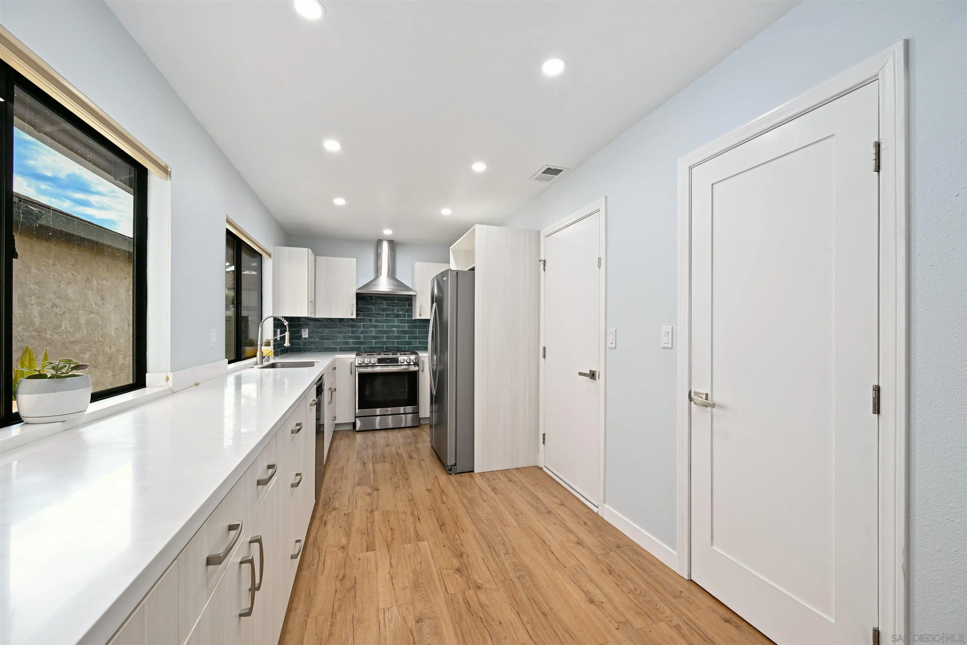 10314 Rochelle Avenue Santee, CA 92071 - Photo 2 of 25 a large kitchen with a lot of counter space and stainless steel appliances