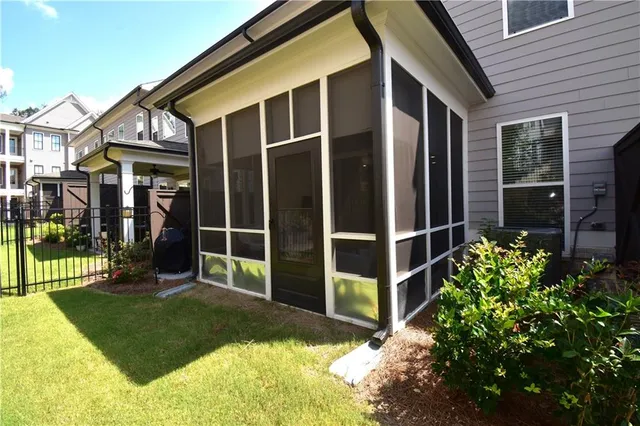a view of a house with a small yard and wooden fence