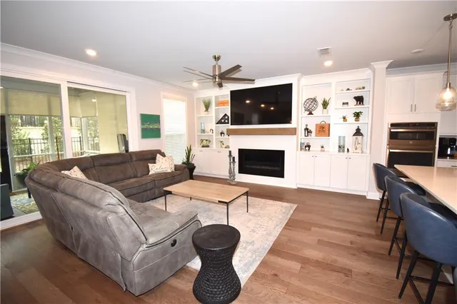 a living room with furniture a flat screen tv and a fireplace