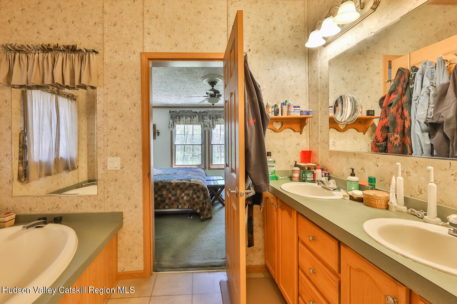 751 Mitchell Hollow Road Windham, NY 12496 - Photo 27 of 37 a en suite bathroom with a granite countertop tub sink and mirror