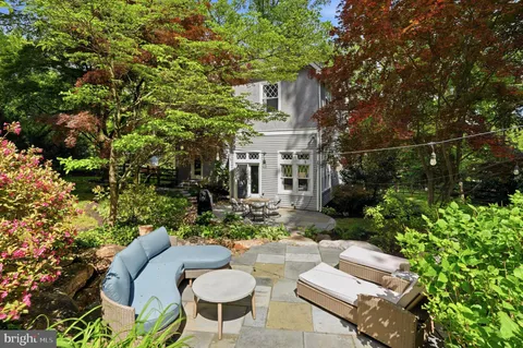 a view of a patio with table and chairs and potted plants