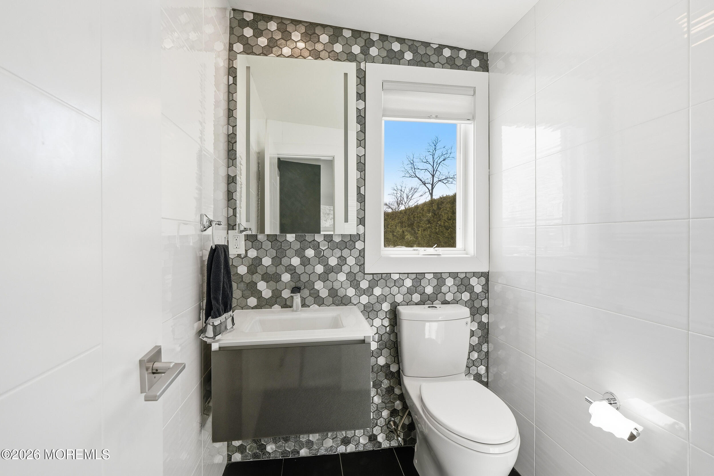 107 Grant Avenue Deal, NJ 07723 - Photo 16 of 38 a bathroom with a toilet sink and mirror