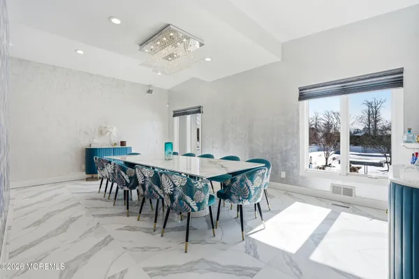 a view of a dining room with furniture and window