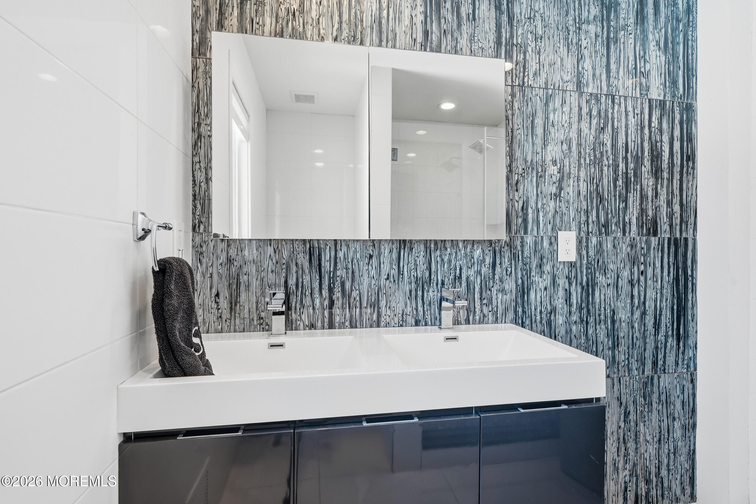 107 Grant Avenue Deal, NJ 07723 - Photo 20 of 38 a bathroom with a sink and a mirror