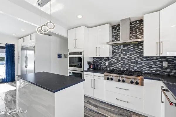 a kitchen with a sink a stove and refrigerator