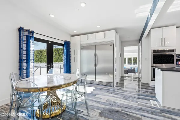a dining room with furniture a chandelier and wooden floor