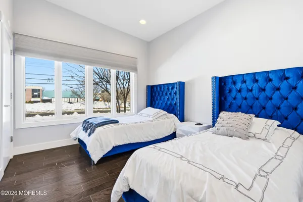 a bedroom with two beds and a large window