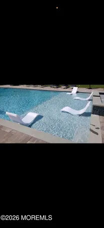 a view of a swimming pool and an outdoor seating