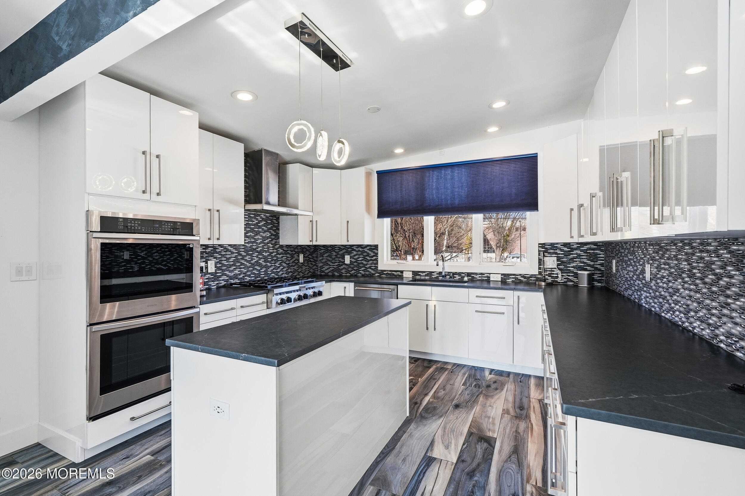107 Grant Avenue Deal, NJ 07723 - Photo 10 of 38 a kitchen with kitchen island granite countertop a sink cabinets and stainless steel appliances