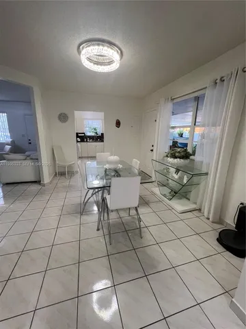 a living room with furniture and a mirror