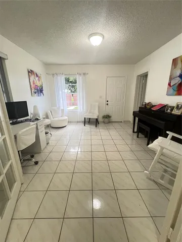 a living room with lots of furniture and a potted plant