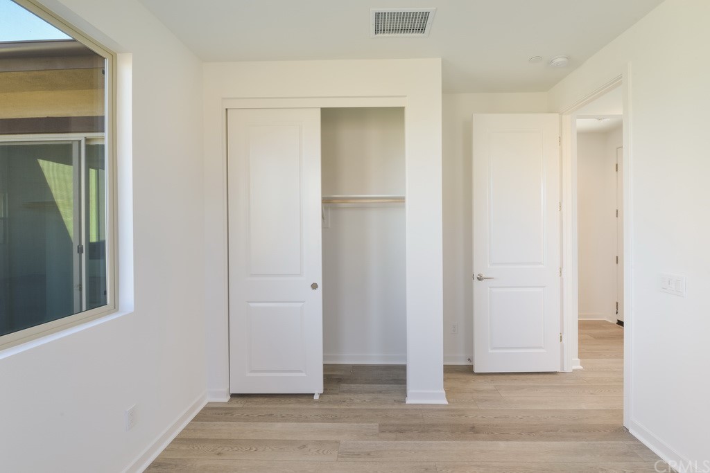 32318 Sonder Way Temecula, CA 92591 - Photo 10 of 18 a view of an empty room with wooden floor