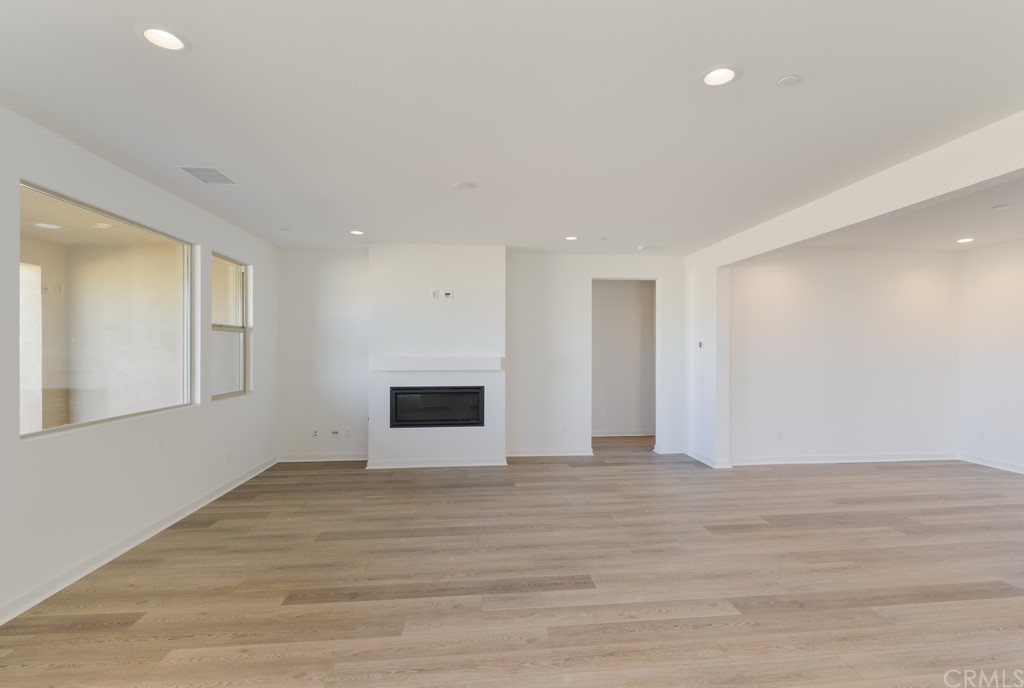 32318 Sonder Way Temecula, CA 92591 - Photo 5 of 18 a view of an empty room with wooden floor and a window