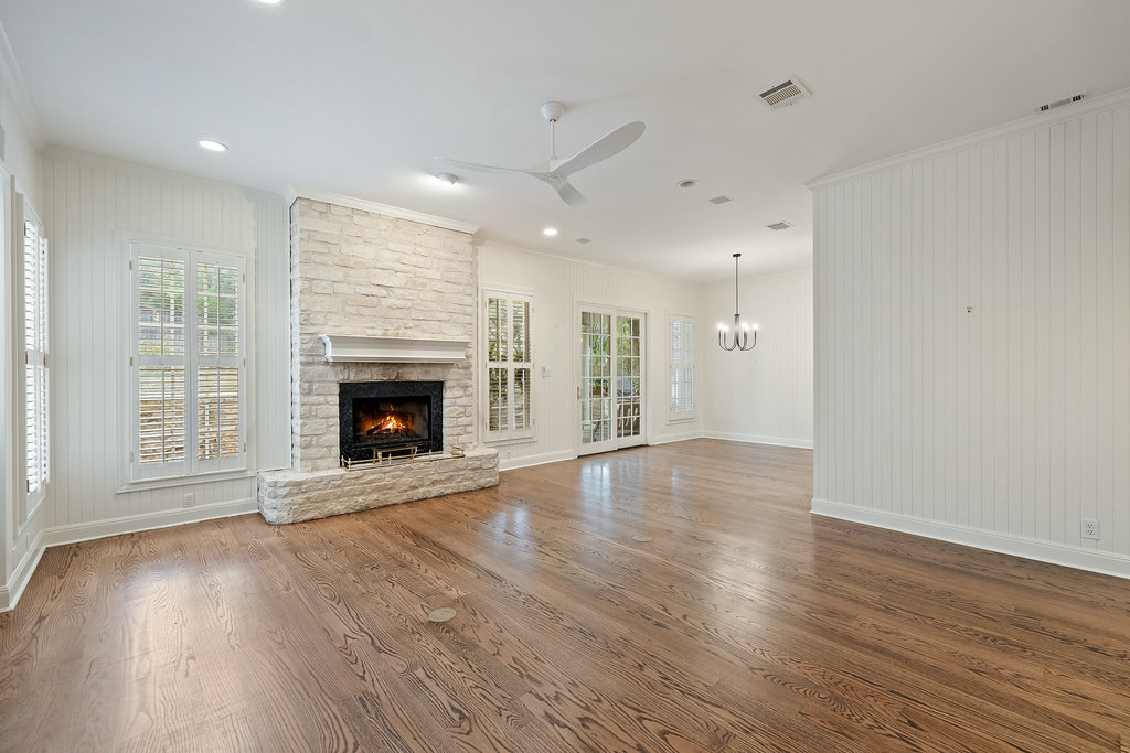 4 Rock Way Cove Austin, TX 78746 - Photo 13 of 26 an empty room with wooden floor fireplace and windows