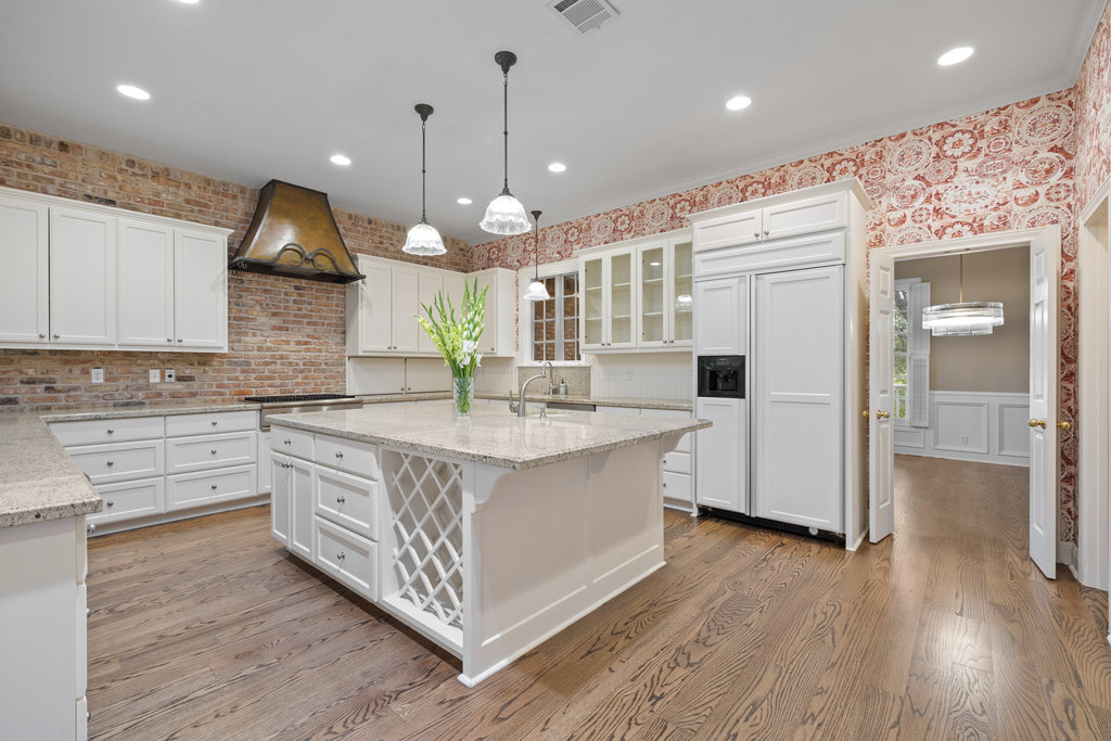 4 Rock Way Cove Austin, TX 78746 - Photo 7 of 26 a large kitchen with stainless steel appliances a large counter top a stove a sink and a wooden floors