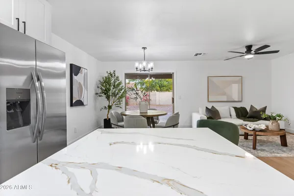 a view of a dining room with furniture and chandelier