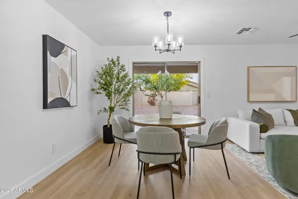 a view of a dining room with furniture and chandelier