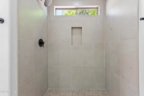 a white toilet sitting next to a shower