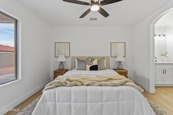 a bedroom with a bed and a lamp