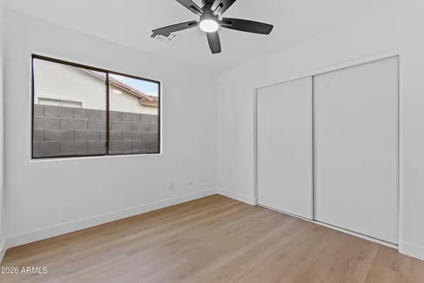 an empty room with ceiling fan and entryway