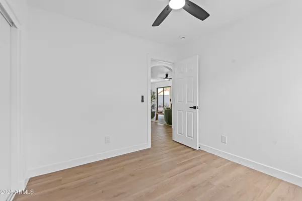 a bathroom with a bathtub shower sink vanity mirror and toilet