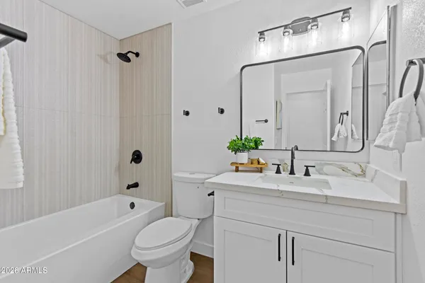 a bathroom with a bathtub and shower